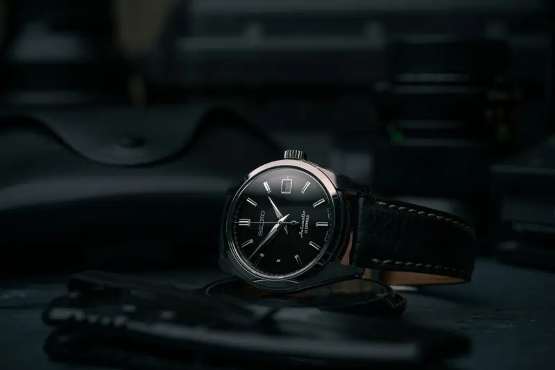 Close-up of a watch dial and case being inspected