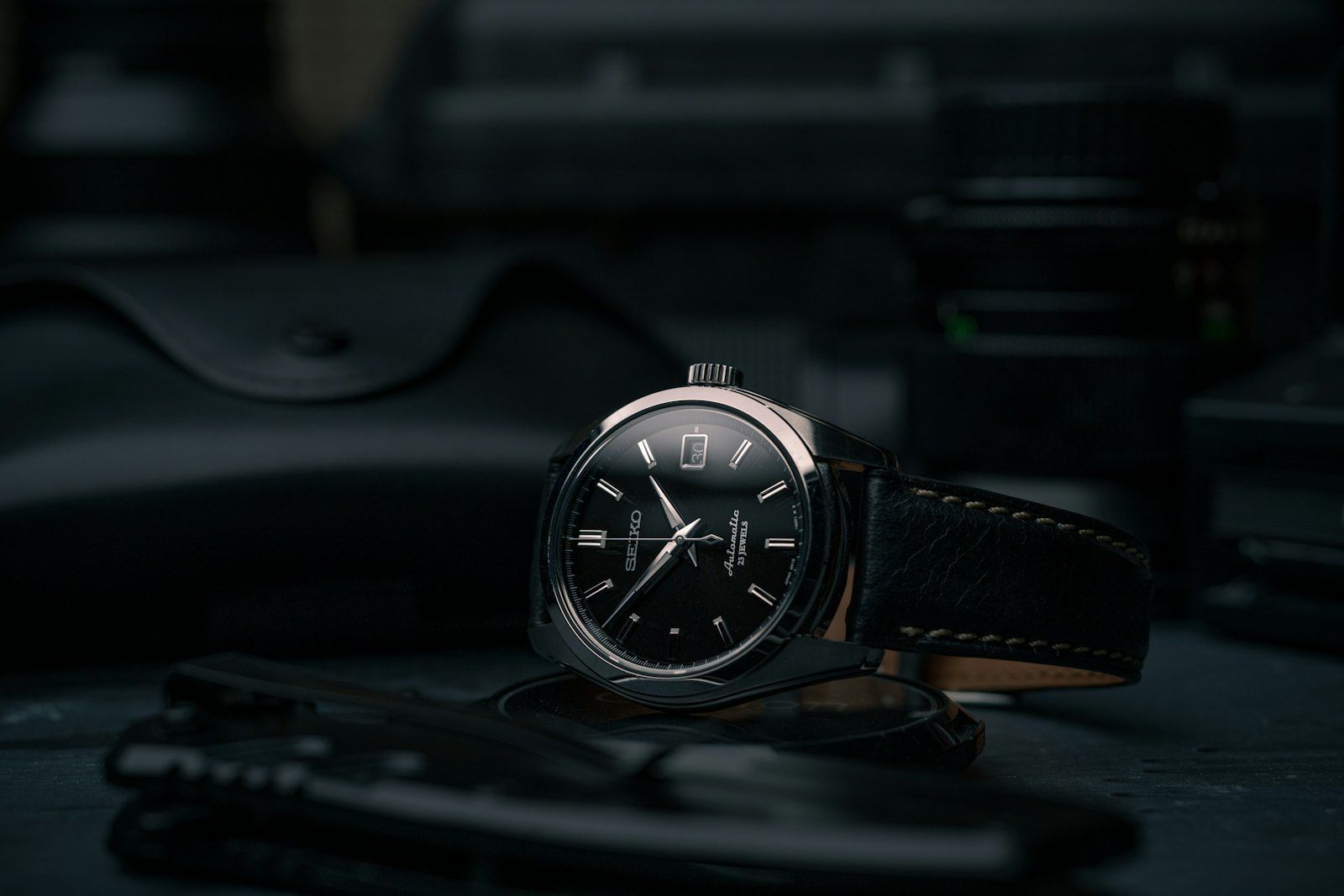 Close-up of a watch dial and case being inspected