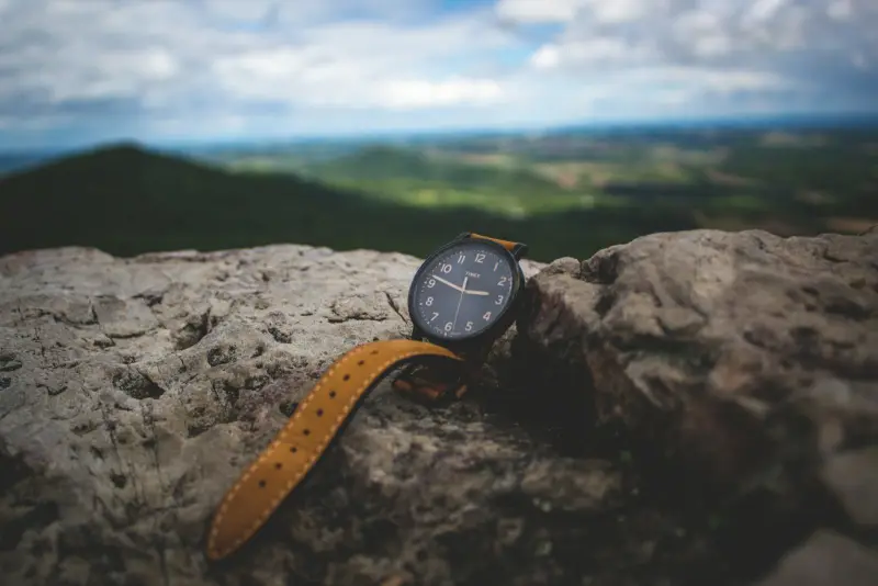 A mechanical watch beside everyday objects